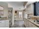 Kitchen view with stone floors, stainless steel appliances, granite countertops, and ample cabinet space at 9333 Dry Dock Dr, Las Vegas, NV 89117