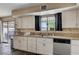 Kitchen featuring white cabinets, granite countertops, a stainless steel dishwasher, and sliding glass doors at 9333 Dry Dock Dr, Las Vegas, NV 89117