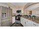 Well-lit kitchen with granite countertops, stainless steel appliances, and white cabinets at 9333 Dry Dock Dr, Las Vegas, NV 89117