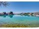 Picturesque waterfront view showcasing clear blue waters, nearby homes, and scenic surroundings under a sunny sky at 9333 Dry Dock Dr, Las Vegas, NV 89117