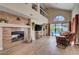 Open-concept living area with brick fireplace and backyard access at 9333 Dry Dock Dr, Las Vegas, NV 89117