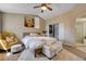 Bright bedroom with a bed, stylish sitting area, and ample natural light creating a cozy and inviting atmosphere at 9333 Dry Dock Dr, Las Vegas, NV 89117