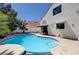 Enjoy a private backyard oasis with a sparkling blue pool, landscaped surroundings, and a covered patio area at 9333 Dry Dock Dr, Las Vegas, NV 89117