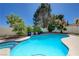 Inviting backyard pool surrounded by lush landscaping and mature trees provides a tranquil outdoor retreat at 9333 Dry Dock Dr, Las Vegas, NV 89117
