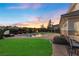 Twilight view of lush backyard with pool, spa, and seating areas, creating a relaxing and inviting atmosphere at 9605 Verlaine Ct, Las Vegas, NV 89145