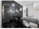 Modern bathroom with a sleek black shower enclosure, a floating vanity, and elegant fixtures at 9605 Verlaine Ct, Las Vegas, NV 89145