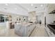 Open-concept kitchen with large center island, stainless steel appliances, and chef's dining counter with abundant light at 9605 Verlaine Ct, Las Vegas, NV 89145