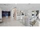 Open-concept kitchen featuring a large center island and a view of the glass-encased wine room at 9605 Verlaine Ct, Las Vegas, NV 89145