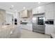 Gourmet kitchen with white custom cabinets, stone countertops, stainless steel appliances, and a chef's range at 9605 Verlaine Ct, Las Vegas, NV 89145