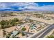 Expansive aerial view of a desert neighborhood featuring homes with pools and views of distant mountains at 9660 W Ann Rd, Las Vegas, NV 89149