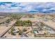 Wide aerial image of a residential area nestled in a desert landscape, under a sky with scattered clouds at 9660 W Ann Rd, Las Vegas, NV 89149