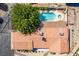 Aerial top-down image of a house, pool, and well-kept landscaping, framed by a large, mature tree at 9660 W Ann Rd, Las Vegas, NV 89149