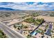 Wide aerial view showcasing homes, desert landscape, and distant mountains under a partly cloudy sky at 9660 W Ann Rd, Las Vegas, NV 89149