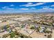 Broad aerial shot of houses and desert landscape set against a cityscape and blue skies with sparse clouds at 9660 W Ann Rd, Las Vegas, NV 89149