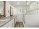 This bathroom boasts dual sinks, stone countertops, and a glass-enclosed shower for a luxurious experience at 9660 W Ann Rd, Las Vegas, NV 89149