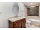 Bathroom boasts a vessel sink and marble countertops, along with a tiled bathtub and surround at 9660 W Ann Rd, Las Vegas, NV 89149