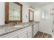 This bathroom boasts dual sinks, stone countertops, and a glass-enclosed shower for a luxurious experience at 9660 W Ann Rd, Las Vegas, NV 89149