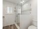 The bathroom includes a glass shower enclosure and a toilet, with a window for natural light at 9660 W Ann Rd, Las Vegas, NV 89149