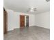 Comfortable bedroom includes tile flooring, a fan, and convenient access to a walk-in closet and bathroom at 9660 W Ann Rd, Las Vegas, NV 89149