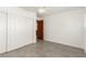 Empty bedroom features gray ceramic tile, ceiling fan, and closet with sliding doors at 9660 W Ann Rd, Las Vegas, NV 89149