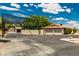 Long driveway leading to a garage and ample parking space at 9660 W Ann Rd, Las Vegas, NV 89149