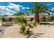 Beautiful home featuring desert landscaping, mature palm trees, and an inviting front entrance at 9660 W Ann Rd, Las Vegas, NV 89149