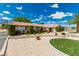 Charming single-story home with desert landscaping, green lawn, and mature trees on a sunny day at 9660 W Ann Rd, Las Vegas, NV 89149
