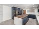 This modern kitchen features blue cabinets, stainless steel appliances, and a large island with a butcher block countertop at 9660 W Ann Rd, Las Vegas, NV 89149