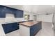 Modern kitchen features blue cabinets, an island, and stainless appliances at 9660 W Ann Rd, Las Vegas, NV 89149