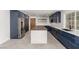 Modern kitchen featuring blue cabinets, stainless appliances, and island at 9660 W Ann Rd, Las Vegas, NV 89149