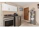 The laundry room features a modern washer and dryer set and a hot water tank at 9660 W Ann Rd, Las Vegas, NV 89149