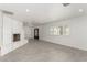 Bright living room features a painted brick fireplace and tile flooring at 9660 W Ann Rd, Las Vegas, NV 89149