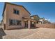 View of a backyard with gravel, a covered patio, and a brick wall fence on a sunny day at 9842 Lost Horse Ave, Las Vegas, NV 89178