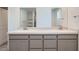 Elegant bathroom with double sink vanity, quartz countertops, soft gray cabinets, and modern fixtures at 9842 Lost Horse Ave, Las Vegas, NV 89178