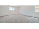 Spacious bedroom featuring neutral carpeting, natural light, and ample space for furniture at 9842 Lost Horse Ave, Las Vegas, NV 89178