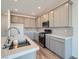 Beautiful kitchen featuring white countertops, stainless steel appliances, and soft gray shaker cabinets at 9842 Lost Horse Ave, Las Vegas, NV 89178