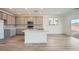 Modern kitchen with white countertops, stainless steel appliances, shaker cabinets, and hardwood floors at 9842 Lost Horse Ave, Las Vegas, NV 89178