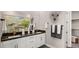 Elegant bathroom with double vanity, white cabinets, dark countertop, and sophisticated decorative wall accents at 12212 Elderwood St, Las Vegas, NV 89138