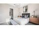 Modern bedroom featuring dark bed frame, gray accent wall, and sleek light fixture at 12212 Elderwood St, Las Vegas, NV 89138