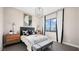 Comfortable bedroom with a modern bed, gray bench, and scenic views outside window at 12212 Elderwood St, Las Vegas, NV 89138
