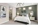 Stylish bedroom showcasing a modern bed, decorative wall art, and an en-suite bathroom with glass shower at 12212 Elderwood St, Las Vegas, NV 89138