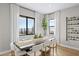 Bright dining room with large windows, hardwood floors, and a modern wine rack at 12212 Elderwood St, Las Vegas, NV 89138