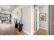 Bright hallway featuring hardwood floors, modern decor, and an open view to the living area and backyard at 12212 Elderwood St, Las Vegas, NV 89138