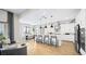 Expansive open-concept kitchen with a large island, counter seating, stainless steel appliances, and access to the dining area at 12212 Elderwood St, Las Vegas, NV 89138