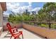 Relaxing balcony with red chairs overlooking lush greenery and a clear blue sky at 1551 Boundary Peak Way, Las Vegas, NV 89135