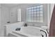 Bright bathroom featuring a soaking tub with decorative windows, perfect for relaxing at 1551 Boundary Peak Way, Las Vegas, NV 89135