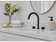 Elegant bathroom vanity with modern fixtures, round mirror, and decorative accents for a luxurious feel at 1551 Boundary Peak Way, Las Vegas, NV 89135