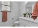 Modern bathroom featuring a vanity with a round mirror, stylish fixtures, and a decorative plant at 1551 Boundary Peak Way, Las Vegas, NV 89135