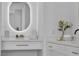 Close-up of a bathroom vanity with modern, illuminated mirror, sleek countertop, and decorative floral accents at 1551 Boundary Peak Way, Las Vegas, NV 89135