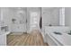 Bright bathroom with wood-look floors, double sink vanity, and a separate bathtub and shower at 1551 Boundary Peak Way, Las Vegas, NV 89135
